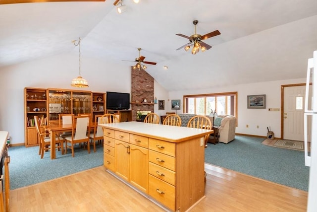 kitchen featuring lofted ceiling, light wood-style floors, open floor plan, and a center island