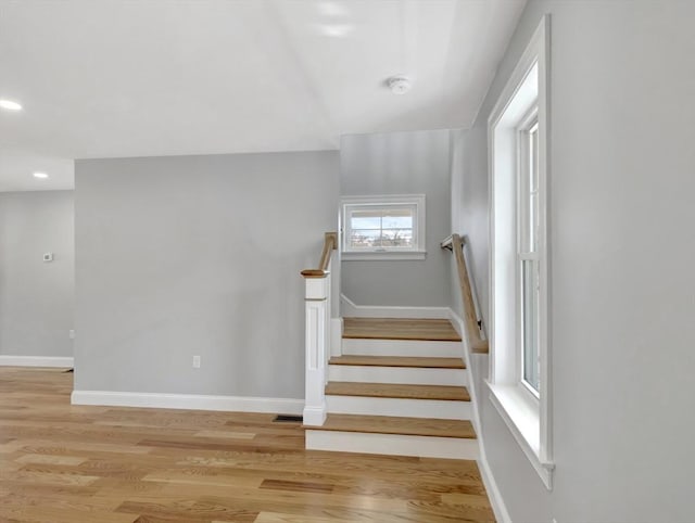 stairs featuring visible vents, recessed lighting, wood finished floors, and baseboards