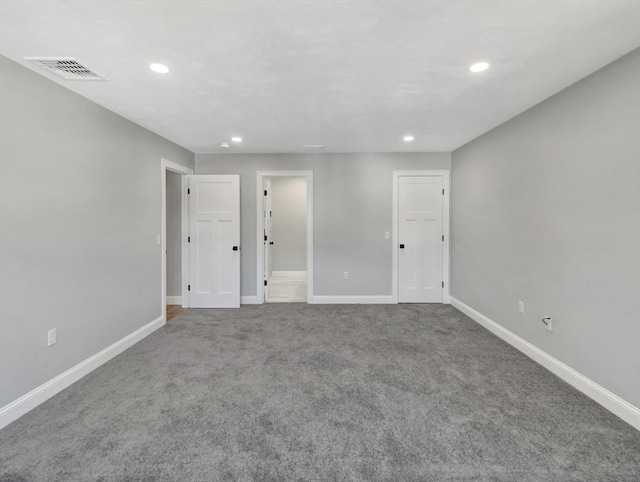 unfurnished room featuring carpet, recessed lighting, baseboards, and visible vents