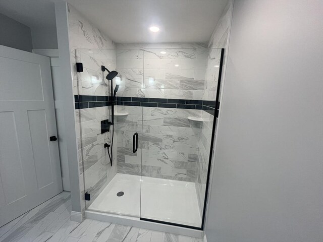 full bath featuring marble finish floor and a stall shower