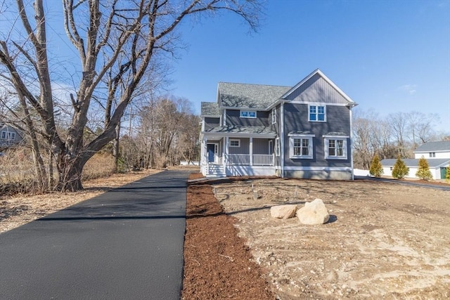 view of front of house featuring aphalt driveway and covered porch