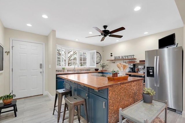 585 Sheridan St Unit 8, Chicopee, MA 01020 - kitchen featuring blue cabinetry, a ceiling fan, stainless steel refrigerator with ice dispenser, a sink, and wood counters