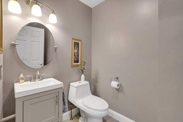 585 Sheridan St Unit 8, Chicopee, MA 01020 - bathroom with vanity, baseboards, and toilet