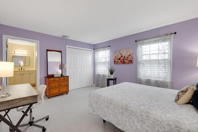 585 Sheridan St Unit 8, Chicopee, MA 01020 - carpeted bedroom featuring a sink, visible vents, a closet, and ensuite bath