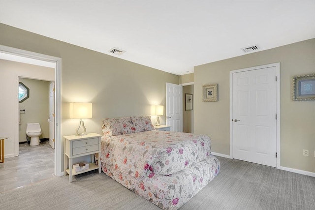 585 Sheridan St Unit 8, Chicopee, MA 01020 - bedroom with light colored carpet, ensuite bathroom, baseboards, and visible vents