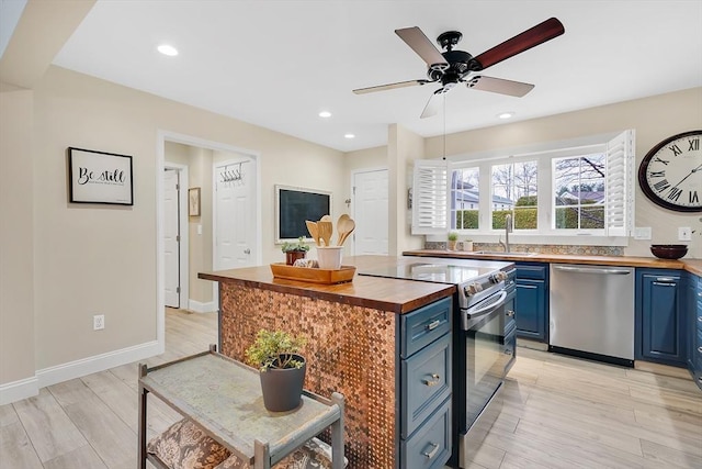 585 Sheridan St Unit 8, Chicopee, MA 01020 - kitchen featuring blue cabinets, wooden counters, dishwasher, a sink, and electric range oven