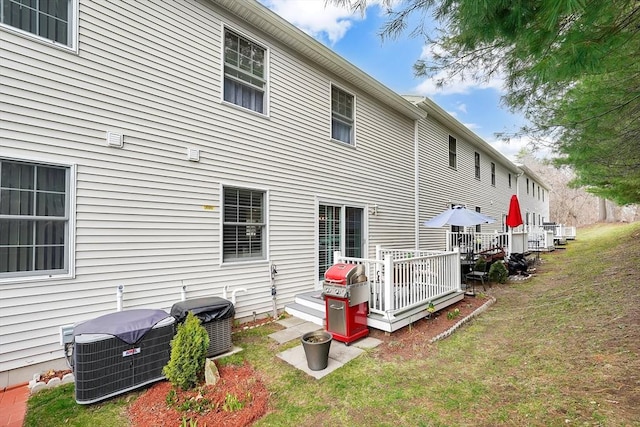 585 Sheridan St Unit 8, Chicopee, MA 01020 - rear view of house with central AC unit and a yard
