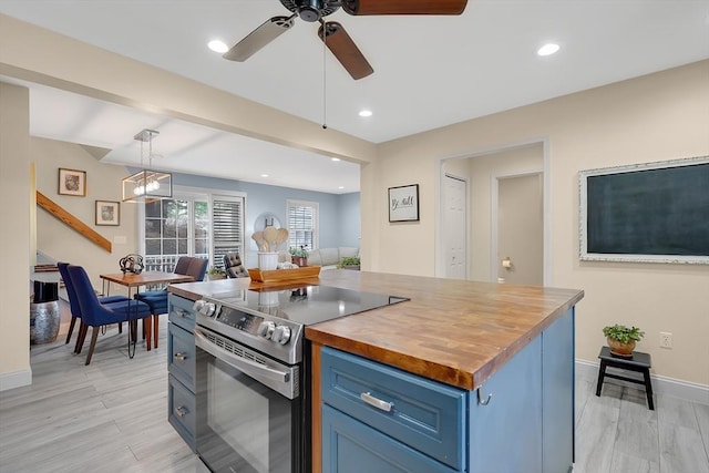 585 Sheridan St Unit 8, Chicopee, MA 01020 - kitchen featuring stainless steel electric range oven, open floor plan, ceiling fan, wood counters, and blue cabinetry