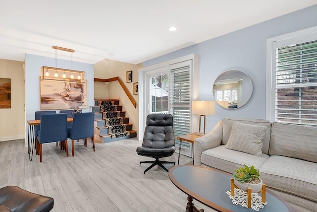 585 Sheridan St Unit 8, Chicopee, MA 01020 - living room featuring baseboards, light wood-style floors, and stairs