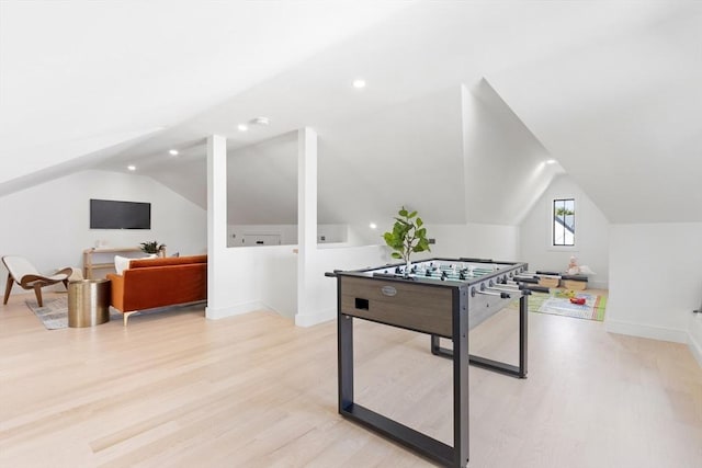 rec room with light hardwood / wood-style floors and lofted ceiling