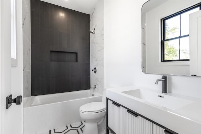 full bathroom with tiled shower / bath combo, vanity, and toilet