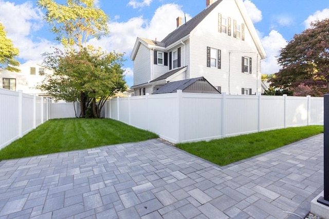 exterior space with a lawn and a patio