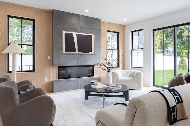 living room with wood walls and a fireplace