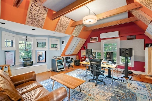 home office with a wall mounted air conditioner, plenty of natural light, and wood finished floors
