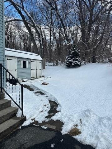 yard covered in snow with an outdoor structure