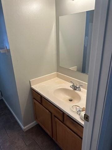 bathroom featuring tile patterned floors, baseboards, and vanity