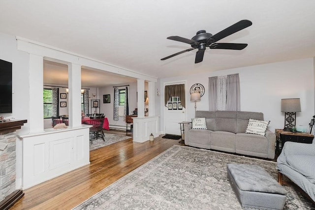 700 S Main St, Bellingham, MA 02019 - living area featuring wood finished floors, ceiling fan, baseboard heating, and decorative columns