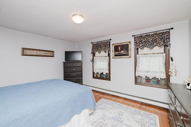 700 S Main St, Bellingham, MA 02019 - bedroom with a baseboard heating unit, ornamental molding, and wood finished floors