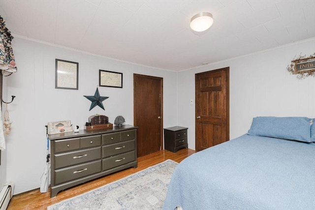 700 S Main St, Bellingham, MA 02019 - bedroom featuring baseboard heating, ornamental molding, and light wood-style floors