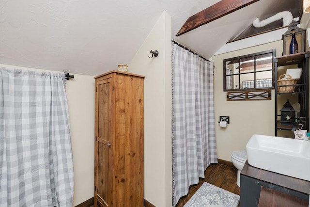 700 S Main St, Bellingham, MA 02019 - full bathroom with vaulted ceiling, wood finished floors, vanity, toilet, and baseboards