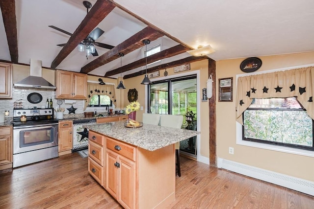 700 S Main St, Bellingham, MA 02019 - kitchen with appliances with stainless steel finishes, wall chimney exhaust hood, a baseboard heating unit, a center island, and backsplash