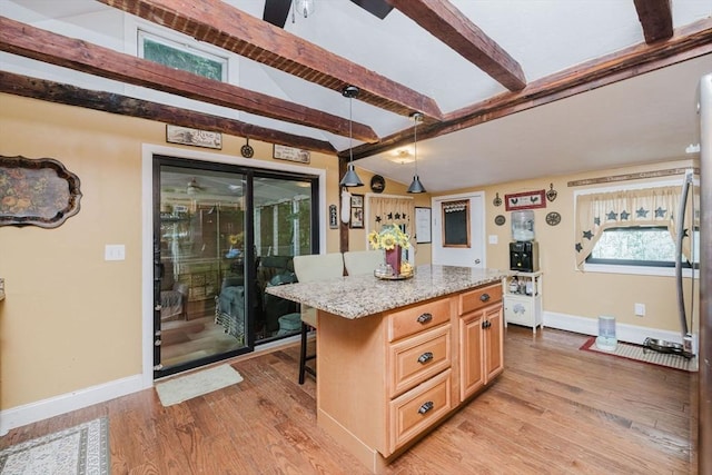 700 S Main St, Bellingham, MA 02019 - kitchen with baseboards, light wood-type flooring, a breakfast bar, and a center island