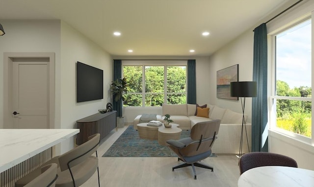 living room with plenty of natural light and light hardwood / wood-style flooring