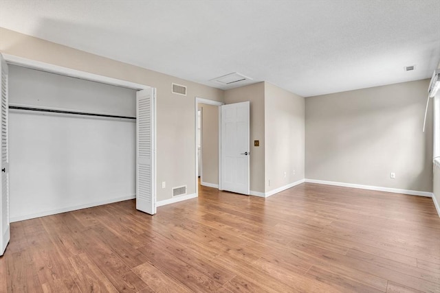 unfurnished bedroom with light hardwood / wood-style floors and a closet