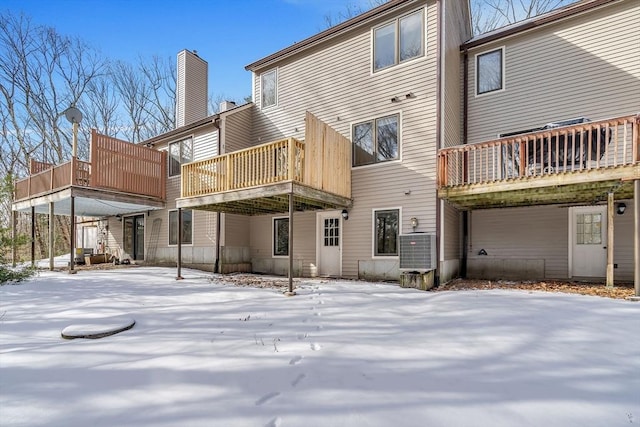 snow covered property featuring central air condition unit