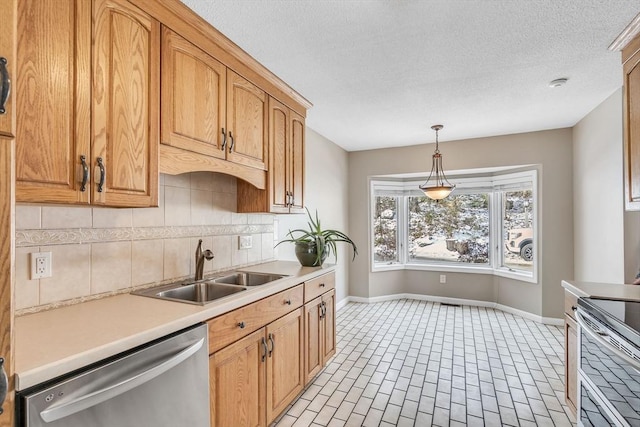 kitchen with pendant lighting, sink, backsplash, stainless steel appliances, and a textured ceiling