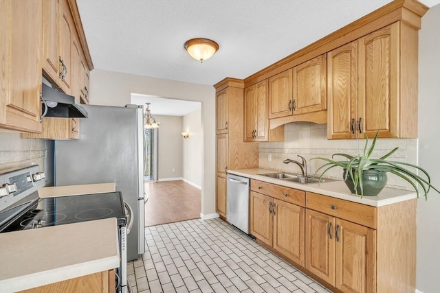 kitchen featuring stainless steel appliances, sink, and decorative backsplash