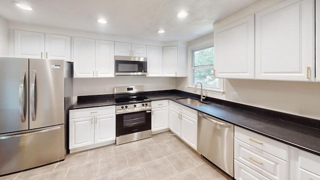 12 Sandra Ave, Burlington, MA 01803 - kitchen with appliances with stainless steel finishes, white cabinetry, recessed lighting, and dark countertops