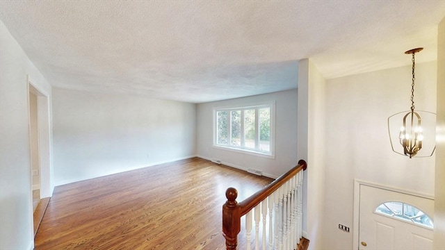 12 Sandra Ave, Burlington, MA 01803 - foyer entrance featuring wood finished floors, a chandelier, and a textured ceiling
