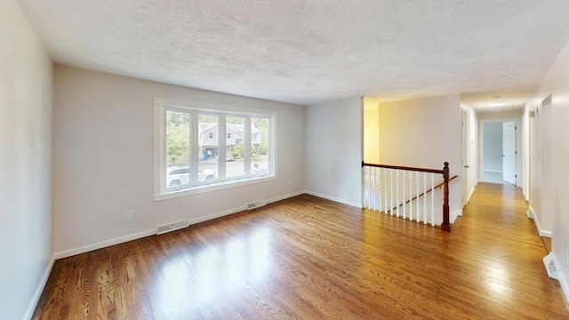 12 Sandra Ave, Burlington, MA 01803 - spare room with wood finished floors and a textured ceiling