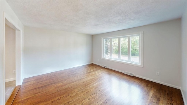 12 Sandra Ave, Burlington, MA 01803 - spare room with wood finished floors and a textured ceiling