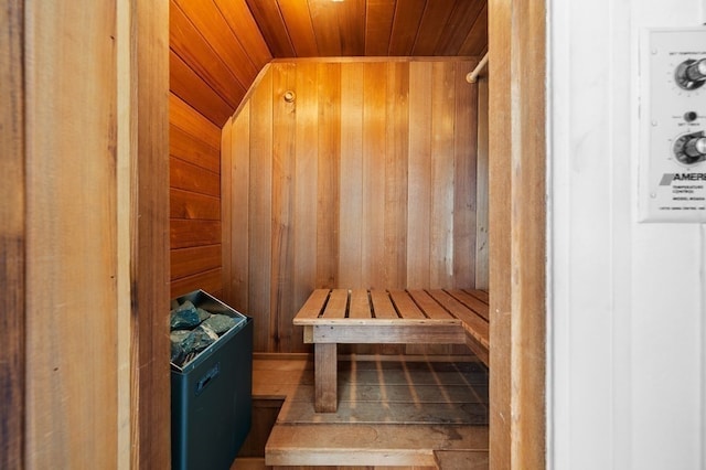 view of sauna with wood walls and wooden ceiling