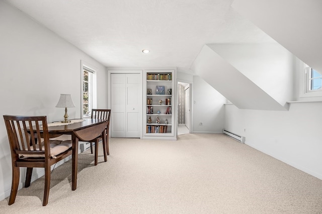 dining space with baseboard heating, light carpet, and plenty of natural light