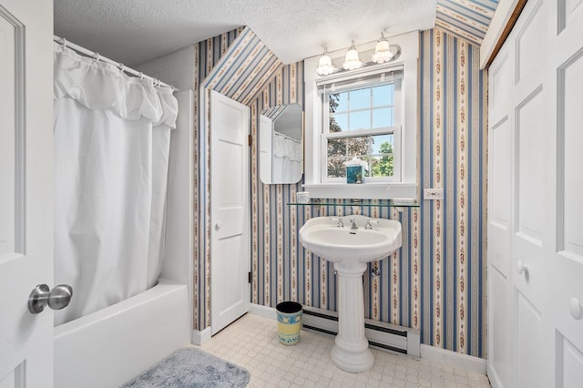 bathroom featuring a textured ceiling and shower / bath combo with shower curtain