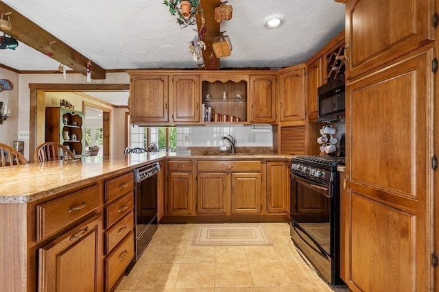 kitchen with kitchen peninsula, beamed ceiling, black appliances, light tile patterned flooring, and sink