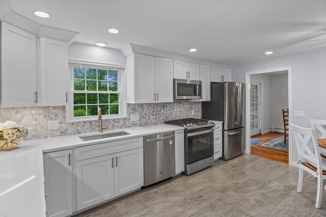 24 Stagecoach, Medfield, MA 02052 - kitchen featuring stainless steel appliances, white cabinets, light countertops, decorative backsplash, and recessed lighting