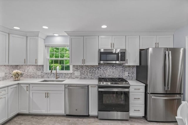 24 Stagecoach, Medfield, MA 02052 - kitchen featuring appliances with stainless steel finishes, light countertops, backsplash, white cabinetry, and recessed lighting