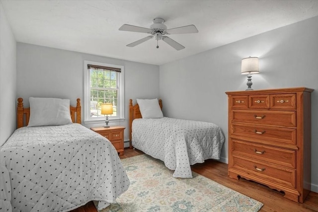 24 Stagecoach, Medfield, MA 02052 - bedroom featuring a baseboard radiator, light wood-style floors, and a ceiling fan