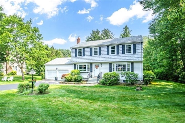 24 Stagecoach, Medfield, MA 02052 - colonial home featuring a chimney, a garage, a front yard, and driveway