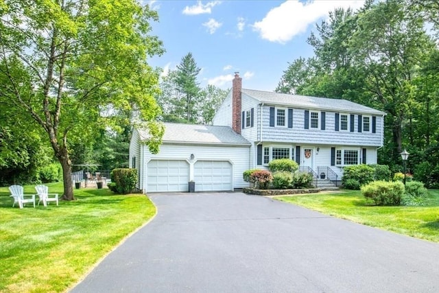 24 Stagecoach, Medfield, MA 02052 - colonial inspired home with a garage, asphalt driveway, a chimney, and a front lawn