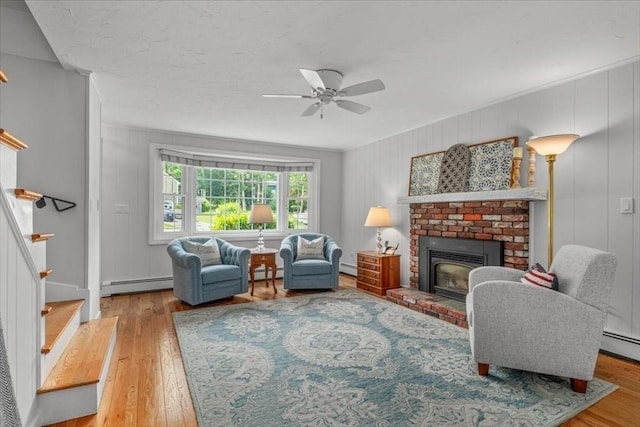 24 Stagecoach, Medfield, MA 02052 - living area featuring baseboard heating, wood finished floors, a fireplace, and a baseboard radiator