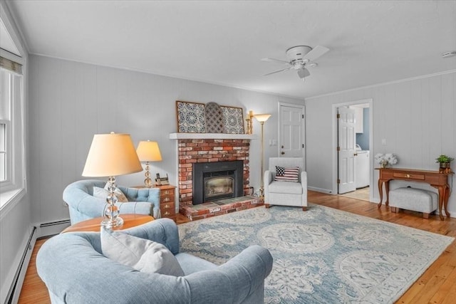 24 Stagecoach, Medfield, MA 02052 - living area featuring wood finished floors, ceiling fan, a baseboard radiator, healthy amount of natural light, and ornamental molding