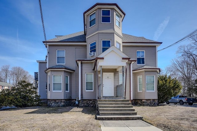 victorian-style house featuring a shingled roof