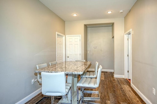 dining space with dark wood-style floors and baseboards