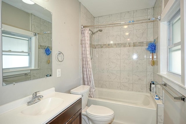 bathroom featuring toilet, shower / bath combo, and vanity