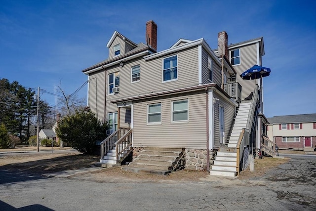 exterior space with a chimney and entry steps